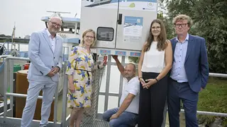 Five people in front of a shore power box