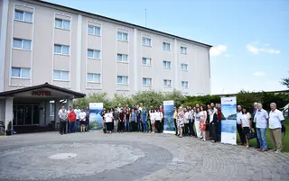 Group of fifty people in front of the hotel building