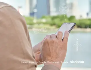 Woman with mobile phone in front of the danube