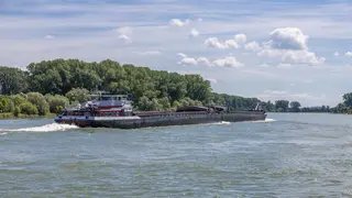 cargo vessel on river, rear view