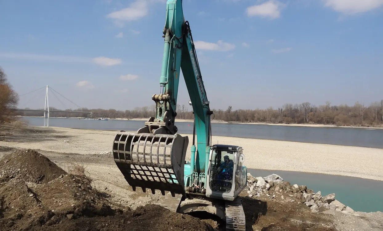 Excavator carrying out riverbank renaturation