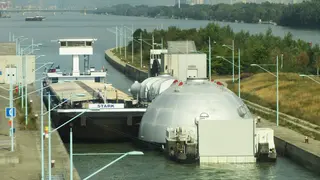 Güterschiff mit übergroßer Ladung in Schleuse