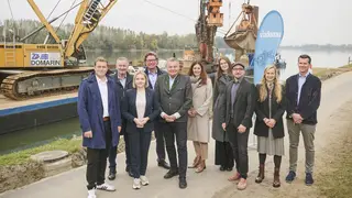 group photo in front of working vessel with machines